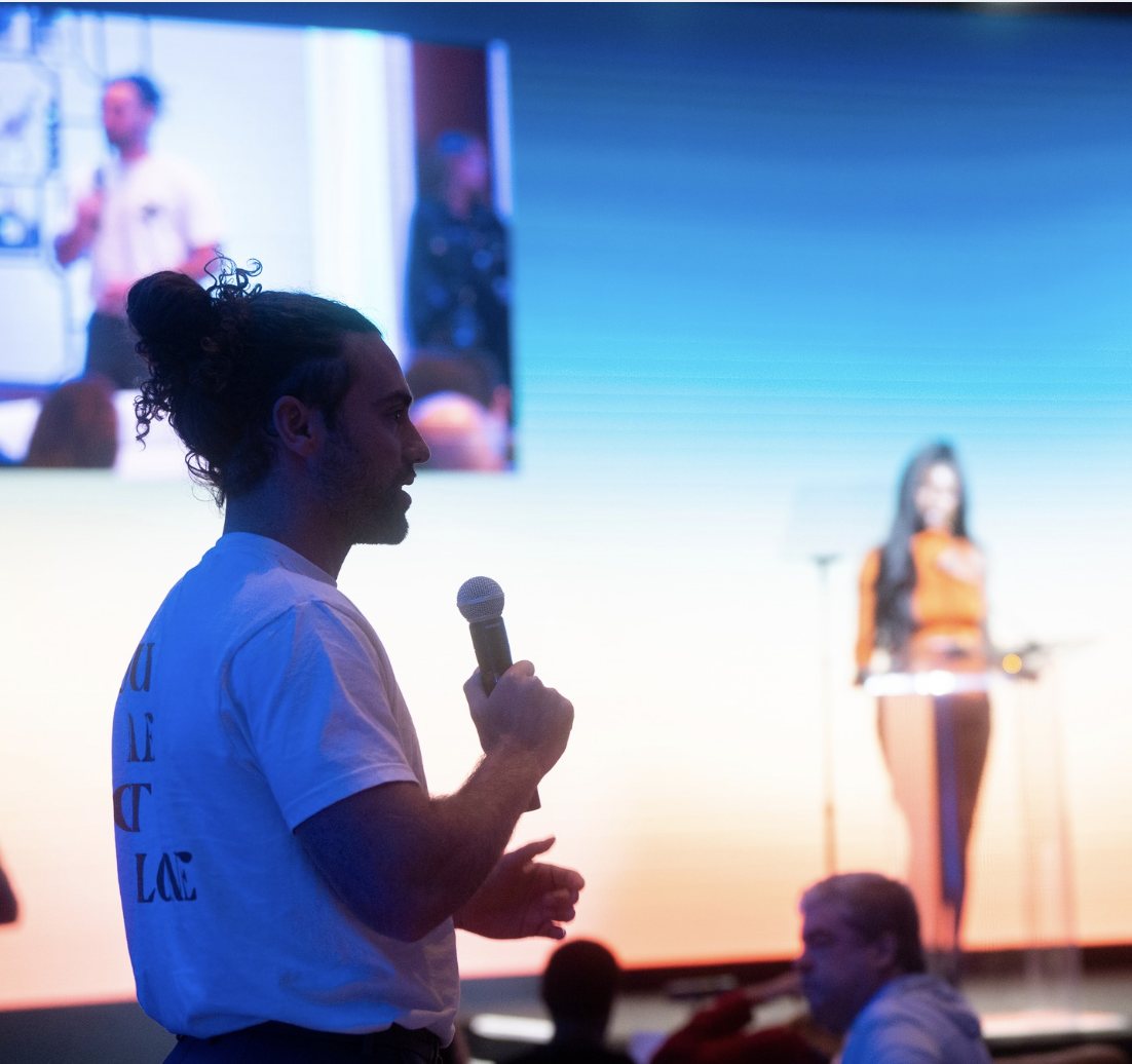 A speaker addressing a live audience